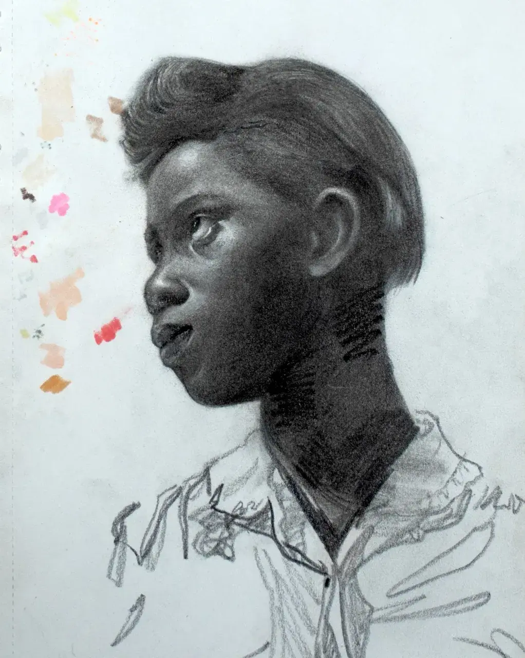 Graphite profile portrait of a young Black man with small color swatches on the paper margin.