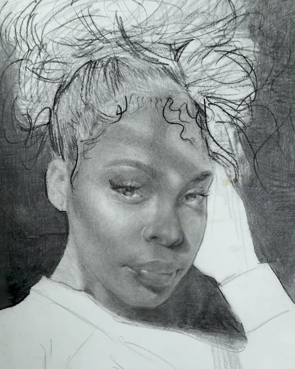 Charcoal portrait with a hand lifted into the hair and soft tonal shading.